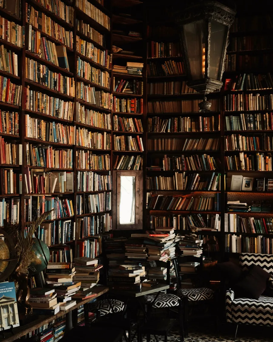 Une bibliothèque ancienne aux rayonnages remplis de livres reliés